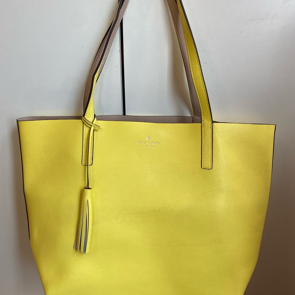 Reversible yellow and pale pink Kate spade.Light markings on the yellow side